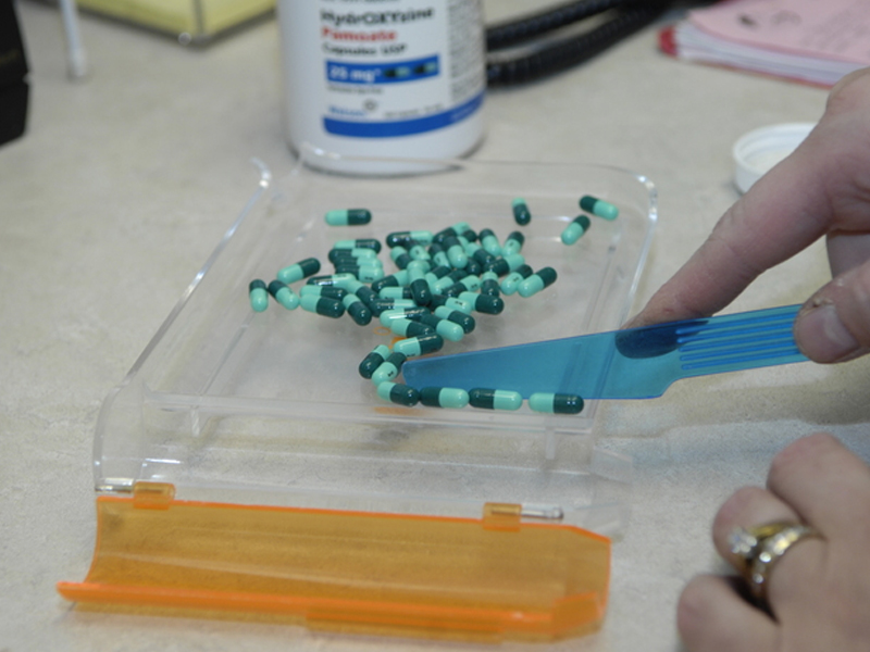 Staff member counting pills